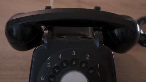 Close-up-of-shot-of-a-hand-picking-up-and-hanging-up-the-receiver-on-a-rotary-dial-phone