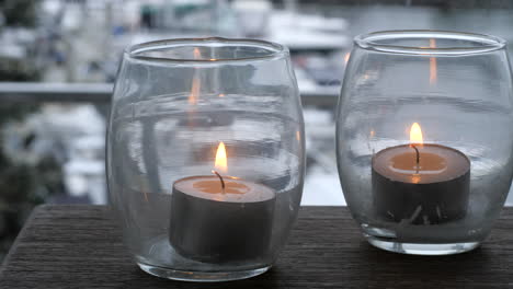 Glowing-Shot-Wax-Candles-In-Glass-Jars,-CLOSE-UP