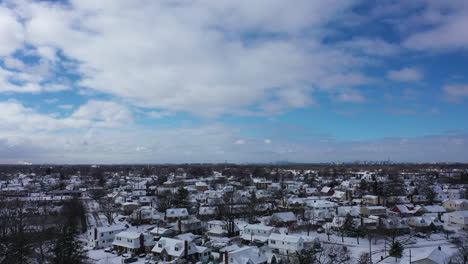 An-aerial-view-over-a-suburban-neighborhood-in-the-morning,-after-a-snowstorm-the-night-before