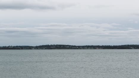 Seagull-Flying-Over-The-Bay-On-A-Cloudy-Day-In-Hull,-Massachusetts-Near-Hull-Gut-And-Boston-Harbor---wide-shot,-static