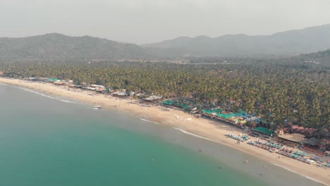 Paradisiac-Palolem-Beach,-stretch-of-white-sand-on-calm-waters-bay,-Goa,-South-India