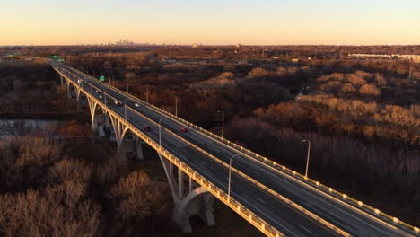 Drone-shot-over-Mendota-Heights-Bridge,-tracking-backwards,-demonstrating-the-huge-scale-of-the-structure