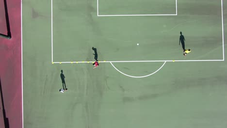 Amateur-Soccer-player-practicing-slalom-movement-with-a-Soccer-ball,-Aerial-view