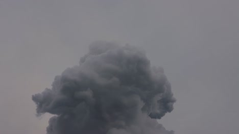 Industrial-black-hot-smoke-pushed-into-the-air-on-a-cloudy-grey-day