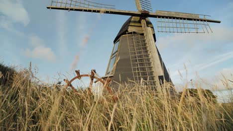 Old-windmill-revealed-through-grass-while-tilting-up
