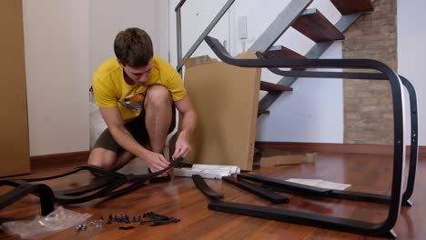 Young-man-assembles-home-furniture