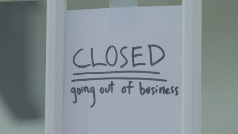 A-going-out-of-business-sign-is-taped-to-a-shutting-door