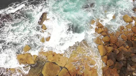 View-from-above-from-drone-looking-down-on-waves-crashing-on-rocks