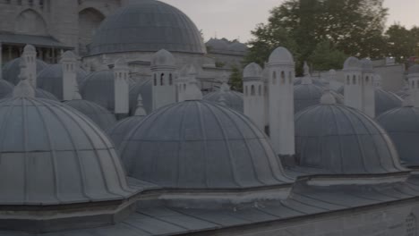 Domes-line-the-top-of-these-buildings-at-sunset