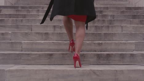 A-woman-climbs-concrete-steps-in-a-city