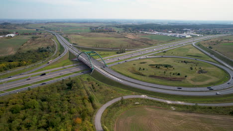 Aerial-panning-shot-of-highway-and-bridge-with-many-cars-near-Gdansk-City,Poland