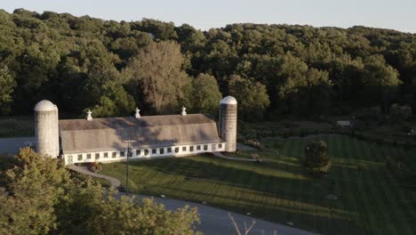 Old-farmhouse-and-silos-in-aerial-orbiting-view