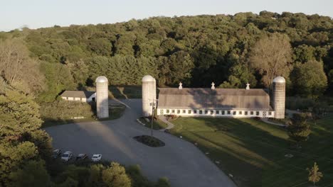 Old-historic-barn-and-silo-towers-in-orbiting-aerial-view