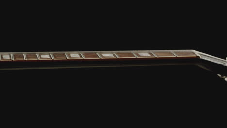 Display-of-an-acoustic-guitar-neck-fretboard