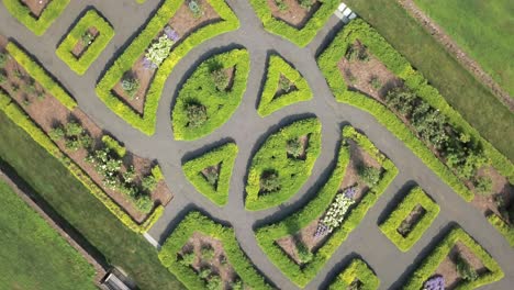 Top-down-rotating-view-of-symmetrical-green-park-and-paths