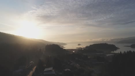 Sun-beams-over-the-hill-behind-town,-Queen-Charlotte,-Haida-Gwaii