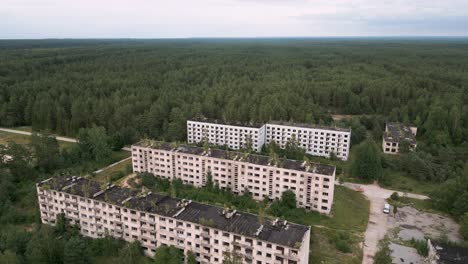 Irbene,-Latvia---Descending-aerial-drone-flight-over-the-soviet-udssr-ghost-town-in-Latvia-in-middle-of-the-endless-forest-with-collapsing-soviet-houses-with-lost-military-officers-from-old-times