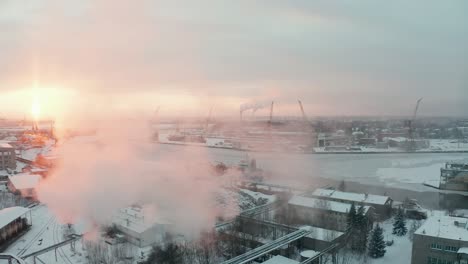 Fly-over-aerial-view-of-industrial-port-in-winter,-covered-with-show