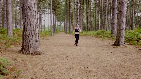 Girl-jogging-towards-you-in-the-woods