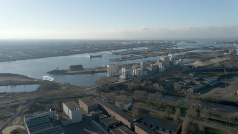 Aerial-overview-of-industrial-terrain-near-a-large-river
