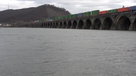 Harrisburg,-Pennsylvania---January-7,-2021:-train-crossing-a-stone-bridge-over-the-Susquehanna-River-near-Harrisburg,-Pennsylvania