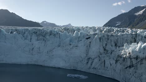 Helicopter-Aerial-View-of-Massive-Glacier-on-Alaskan-Coast-on-Sunny-Day