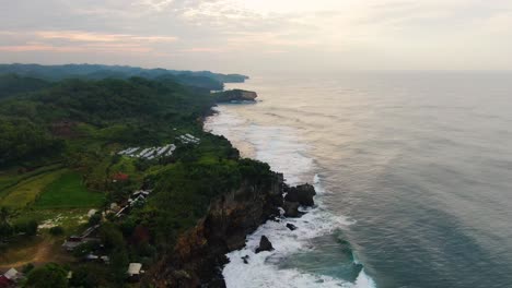 Aerial-view-on-cliffs-on-southern-shore-of-Java-Island,-Indonesia-at-sunset