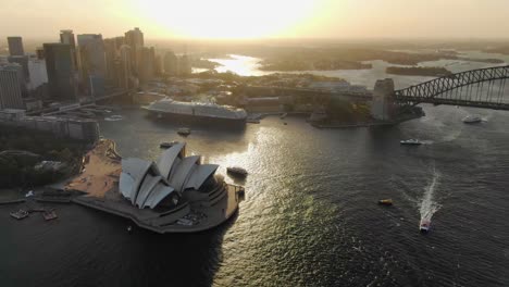 Aerial-circling-over-Sydney-Opera-house-and-Harbor-Bridge-with-cityscape-in-background