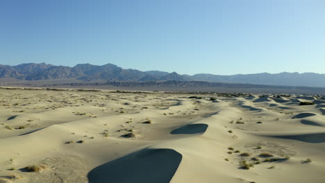 Drone,-aerial-footage-flying-through,-empty,-dry,-hot-sand-dunes-in-the-desert