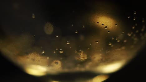 Bubbles-trapped-from-carbonization-escaping-the-bottom-of-a-Champagne-glass---Extreme-close-up-shot