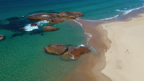 Aerial-view-of-beautiful-quiet-Australian-beach,-hot-summer-day