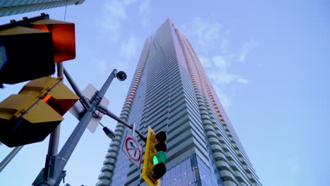 Low-angle-wide-exterior-shot-of-One-Bloor-condo-building-in-Yorkville,-street-light-in-foreground