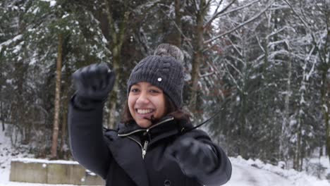 Young-asian-woman-having-fun-in-the-snow-jumping-and-warming-up-in-slow-motion
