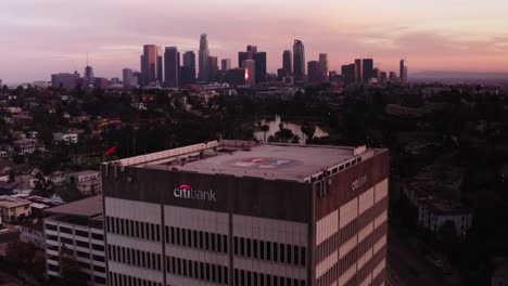 Aerial-shot-flying-over-building-to-reveal-Downtown-Los-Angeles-during-sunset