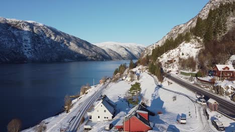 Overview-of-Fossmark-between-highway-E16-from-Bergen-and-railroad-between-Bergen-and-Voss-to-Oslo---Winter-scenic-aerial-with-Veafjorden