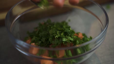 Close-shot-of-a-chef-seasoning-salmon-with-herbs