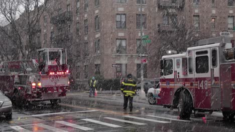 Heavy-snowfall-pouring-over-FDNY-trucks-and-Personnel-attending-ConEd-fire,-in-Manhattan,-New-York---Wide-static-shot