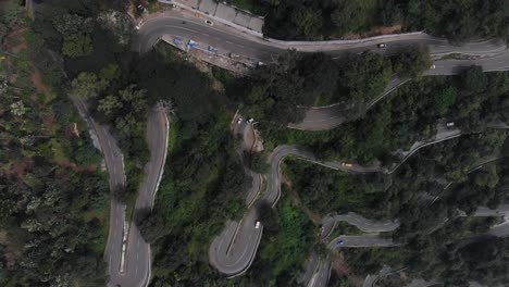 Hairpin-bends-in-Yercaud,-India-covered-with-endless-vast-forest-with-trees-growing-rapidly
