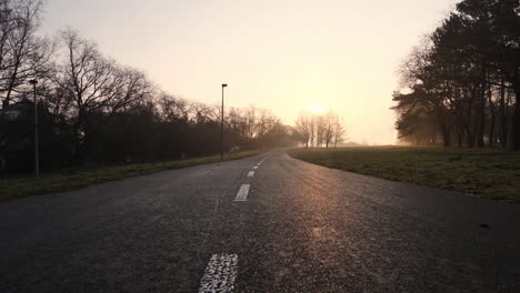 Empty-Road-in-Suburbia-on-Sunrise-Sunlight,-Cinematic-Low-Angle-View