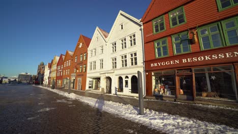 Motion-shot-walking-along-famous-Bryggen-district-with-beautiful-sunrise-lights