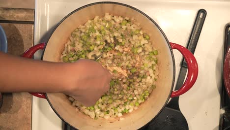 Sautéing-onions-and-peppers-to-make-a-sauce-to-roast-chicken-in-the-Dutch-oven---overhead-view-POT-ROASTED-CHICKEN-SERIES
