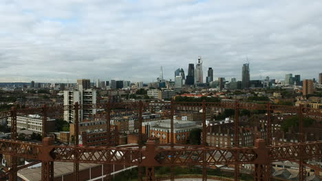 Ariel-view-of-the-Bethnal-Green-gas-holder-in-East-London-with-the-cloudy-city-of-London-skyline