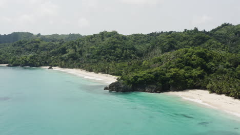 AERIAL---White-sand-beach,-Playa-Rincon-beach,-Dominican-Republic,-spinning-shot