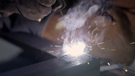 Welding-metal-in-close-up-slow-motion-while-sparks-are-flying-away