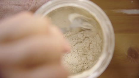 TOP-DOWN---Sourdough-starter-is-mixed-with-a-spoon-after-being-fed