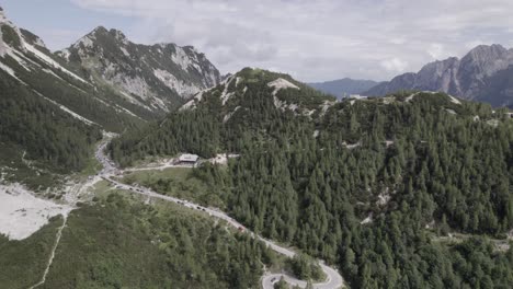 Drone-video-with-descriptive-frontal-shot-over-the-Vrsc-pass-in-Slovenia-with-mountains-on-the-horizon