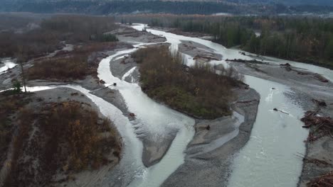 Powerful-river-flooded-vast-to-sides-in-Canada-forestry-landscape,-aerial-drone-view