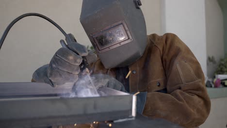Welding-sparks-flying-away-while-welding-in-slow-motion-shot