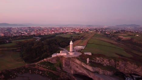 Cabo-Mayor-Lighthouse-and-cityscape-of-Santander-in-horizon,-aerial-view
