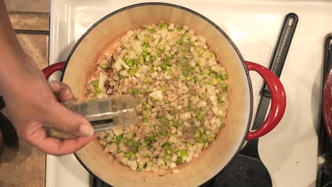 Seasoning-the-celery-and-onions-with-thyme-to-make-a-sauce-for-a-pot-roasted-chicken-recipe---POT-ROASTED-CHICKEN-SERIES